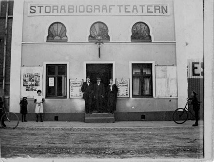 Och på tal om Frans Hermodsson, mannen som reste till Klondyke, är här ett tidigt foto av Stora biografteatern. Huset uppfördes 1910 och fotot är taget någon gång mellan 1920 och 1922. 1922 byggdes nämligen biografen om och namnet ändrades till Palladium. Frans båda systrar, Olga och Anna, skötte biografen och i början av 1920-talet byggde de ett rött tegelhus i hörnan Norregatan-Repslagaregatan, bredvid biografen. De bosatte sig på ovanvåningen och drev pantbanken i nedanvåningen. Biografen lades ner 1974 och därefter användes byggnaden bland annat som lagerlokal. Arkitekt Pierre Dupont byggde samman biograflokalen med det röda tegelhuset och år 2000 invigdes Eslövs stadsbibliotek i lokalerna.