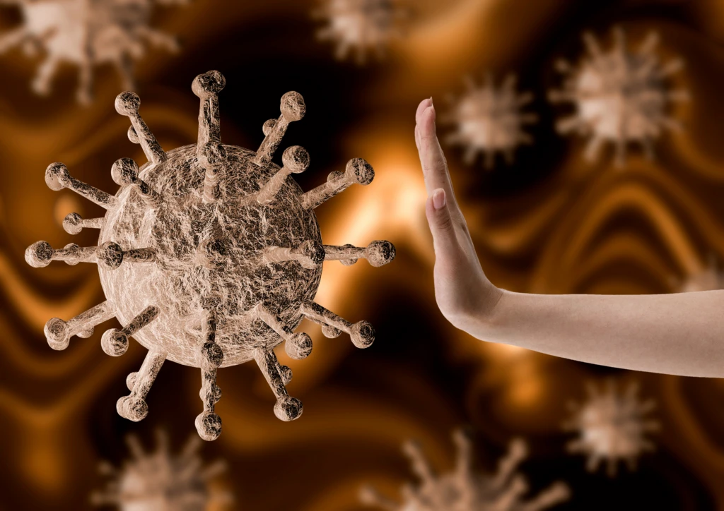 Hand som stoppar ett förstorat virus