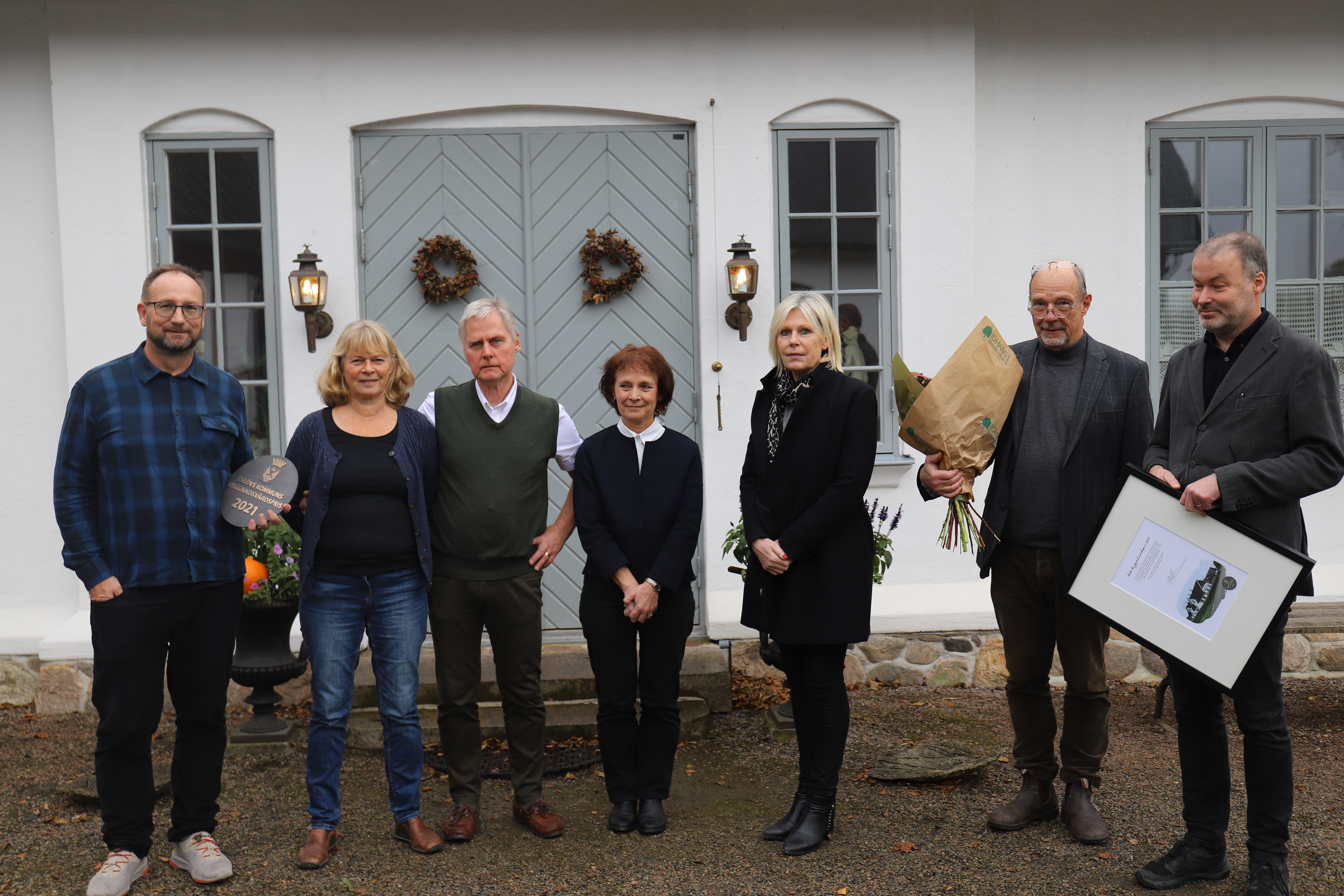 Anders och Anne-Marie Borgqvist tilldelas priset f&ouml;r flera byggnader i Billinge som de restaurerat med omsorg och som genom deras f&ouml;rfinande d&auml;rigenom bidrar till upplevelsen av en attraktiv bymilj&ouml;. Fr&aring;n v&auml;nster: Johan Andersson (S), kommunstyrelsens ordf&ouml;rande, Anne-Marie och Anders Borgqvist. Catharina Malmborg, kommunstyrelsens f&ouml;rsta vice ordf&ouml;rande, Eva Hallberg, kommundirekt&ouml;r, Torsten Helander, planarkitekt och Mikael Vallberg, planchef.