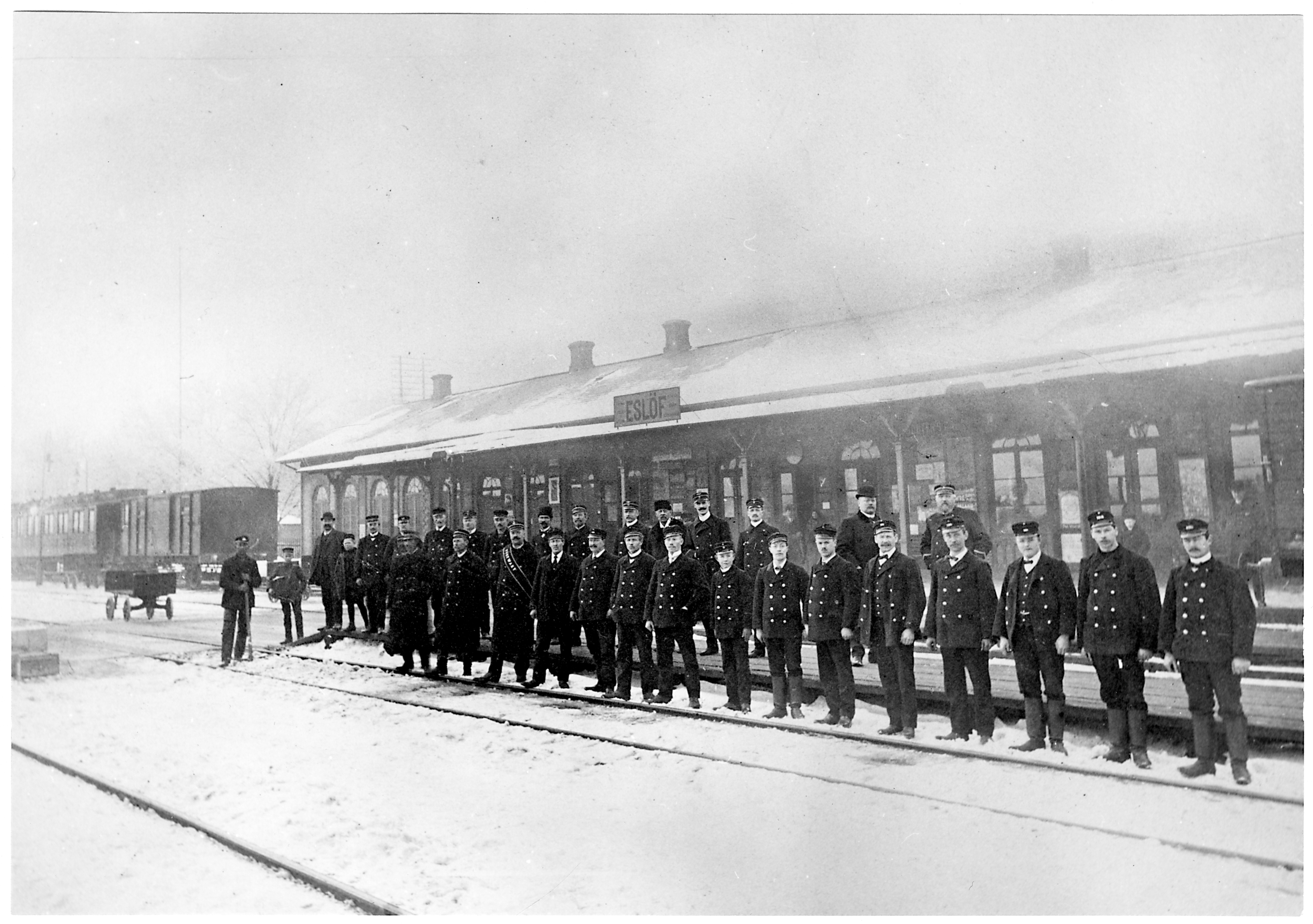 Personal utanf&ouml;r Esl&ouml;vs j&auml;rnv&auml;gsstation omkring 1907. K&auml;lla: digitaltmuseum.se/J&auml;rnv&auml;gsmuseet.